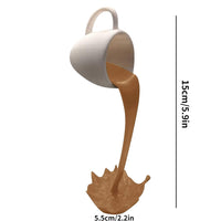 Sculpture de tasse volante avec liquide qui se renverse. Décoration en résine