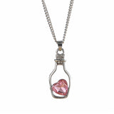 Chaîne avec pendentif cœur dans une bouteille